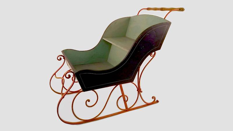 Schiebeschlitten aus Holz, außen schwarz und innen grün, mit gusseisernen, verzierten Kufen